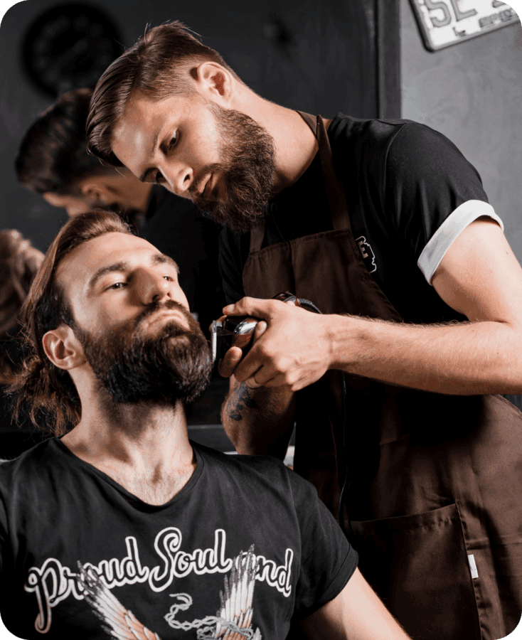 Barber trimming a beard